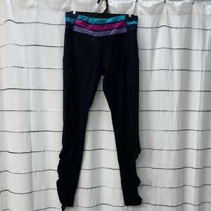 High waisted black leggings with color detail on the waist.